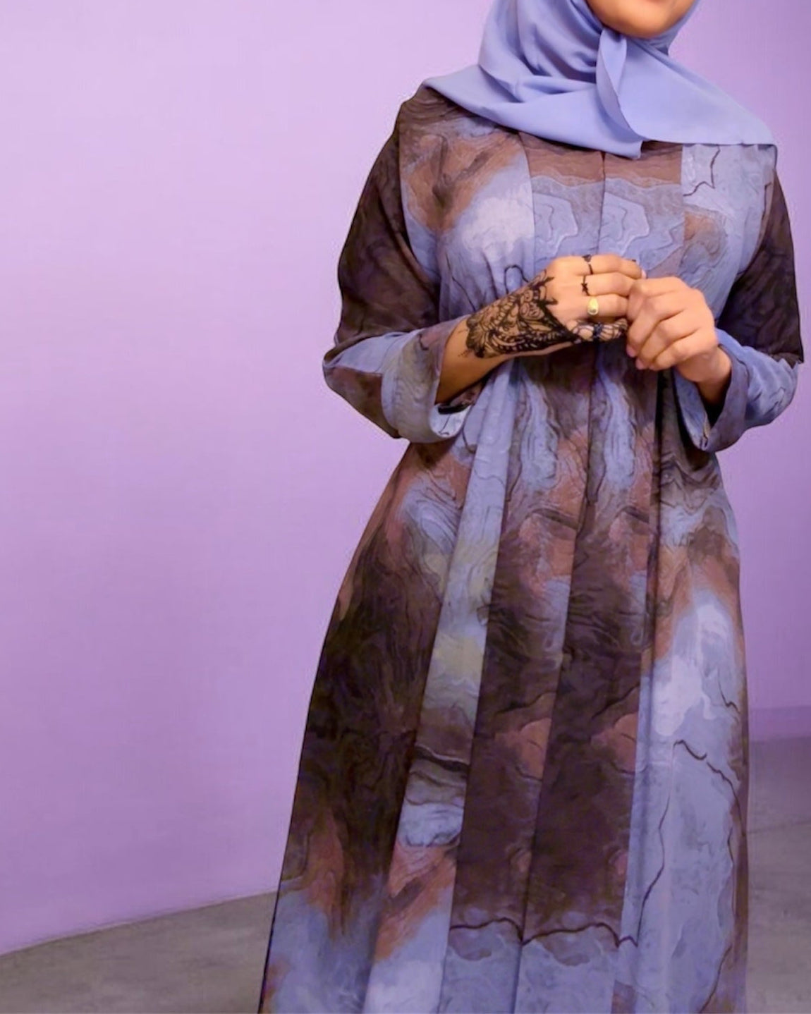 '' Oceanic elegance in every fold—this navy-blue abaya features a dreamy, wave-like print that flows beautifully with every step. Paired with a matching scarf for a seamless look.