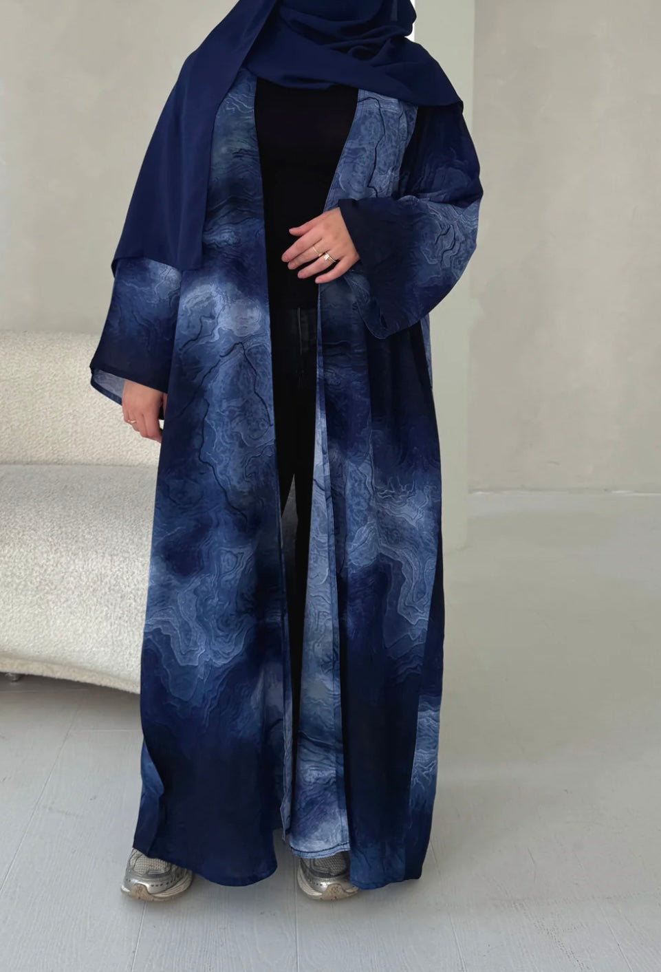 Oceanic elegance in every fold—this navy-blue abaya features a dreamy, wave-like print that flows beautifully with every step. Paired with a matching scarf for a seamless look.